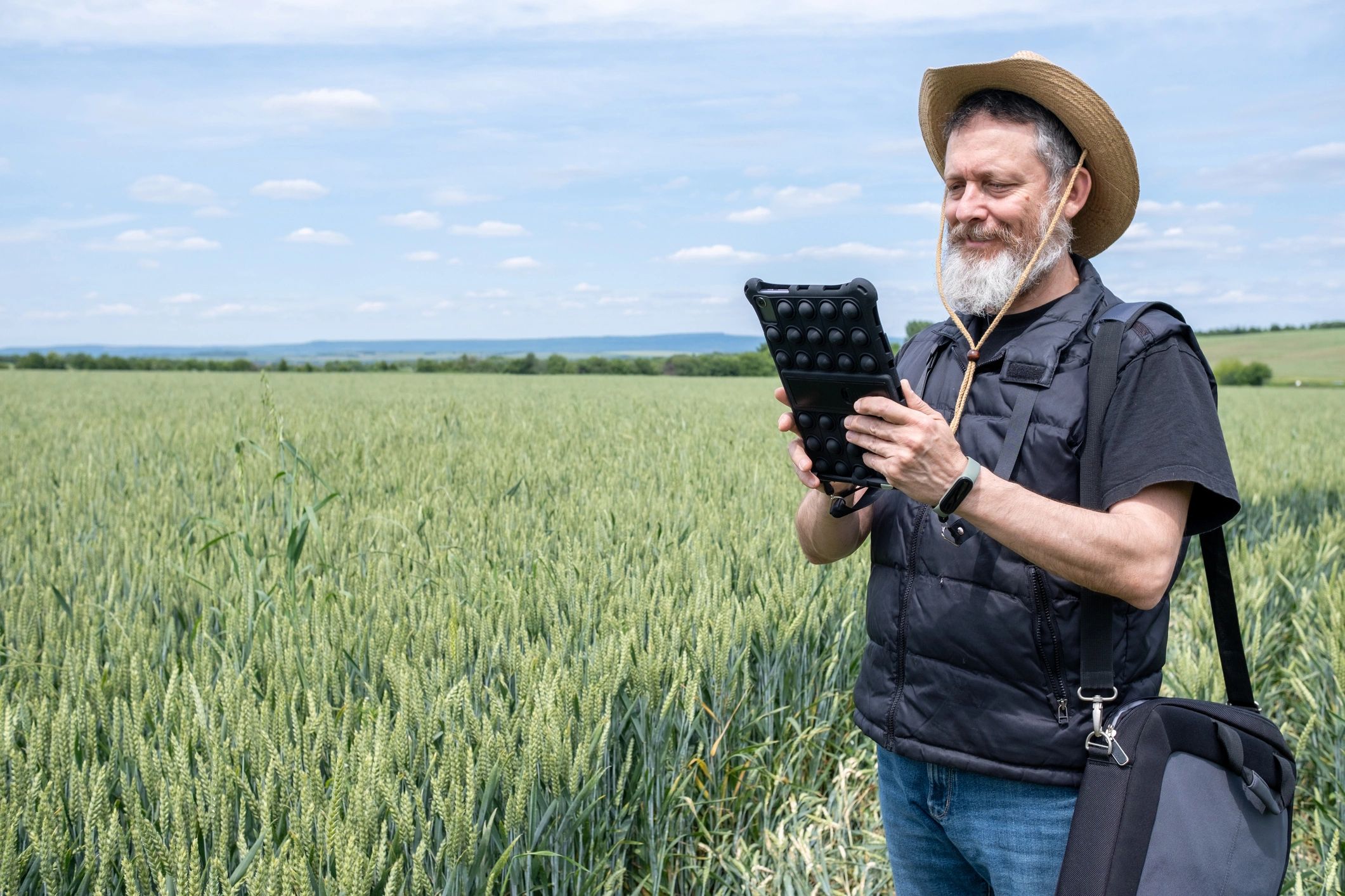 Agriculture professional using digital tools in a crop field